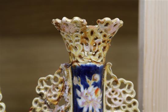 A pair of Zsolnay Pecs reticulated vases, floral-decorated on a blue ground and heightened in gilt height 20cm (a.f.)